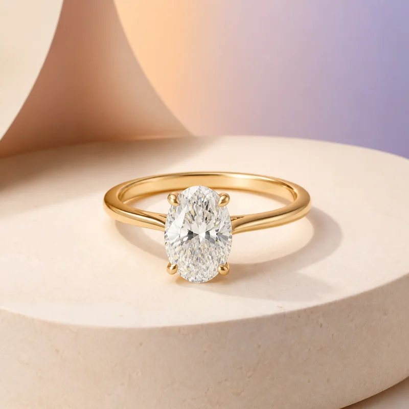 Oval solitaire engagement ring in yellow gold